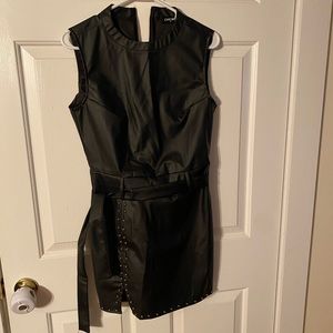 Medium black dress with studded trim line.